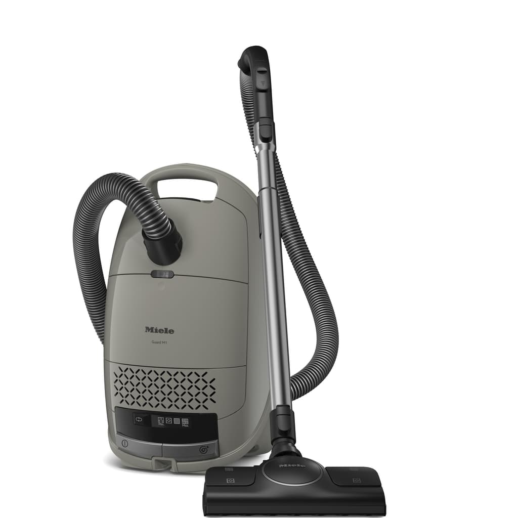 Miele Guard M1 Silence casagrå sladdad påsdammsugare med slang och golvmunstycke på vit bakgrund